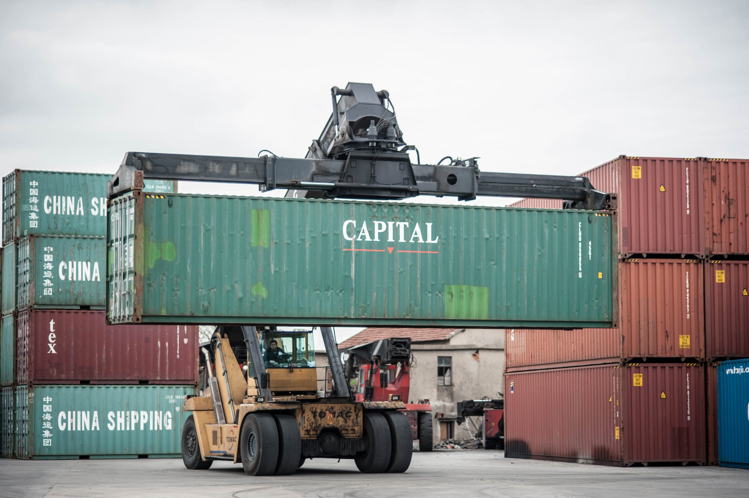 heavy machinery transporting an asset container at the port