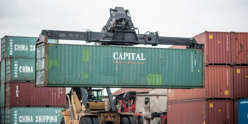 heavy machinery transporting an asset container at the port